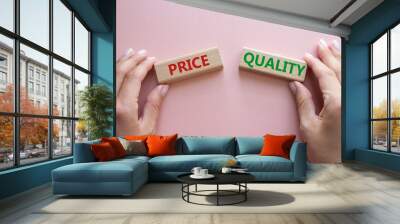 Price or Quality symbol. Concept word Price or Quality on wooden blocks. Businessman hand. Beautiful pink background. Business and Price or Quality concept. Copy space Wall mural