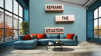 Reframe the situation symbol. Concept words Reframe the situation on wooden blocks. Beautiful grey green background. Business concept. Copy space. Wall mural