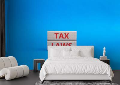 Tax Laws symbol. Concept word Tax Laws on wooden blocks. Beautiful blue background. Business and Tax Laws concept. Copy space Wall mural