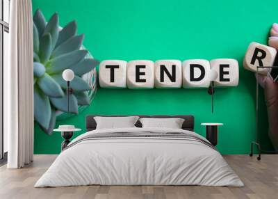 Tender symbol. Concept word Tender on wooden cubes. Businessman hand. Beautiful green background with succulent plant. Medicine and Tender concept. Copy space. Wall mural