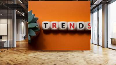 Trends symbol. Concept word Trends on wooden cubes. Beautiful orange background. Business and Trends concept. Copy space. Wall mural