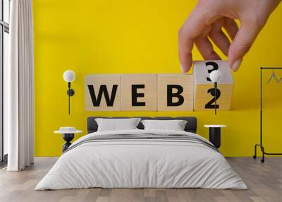 Web 3 vs Web 2 symbol. Businessman Hand turns cubes and changes the word web 2 to web 3. Beautiful yellow background. Business concept. Copy space Wall mural