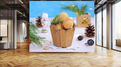 Shortbread cookies Nuts stuffed with chocolate paste or condensed milk in a wooden jar in a Christmas and New Year style on a light concrete background. Cookie recipes. Wall mural