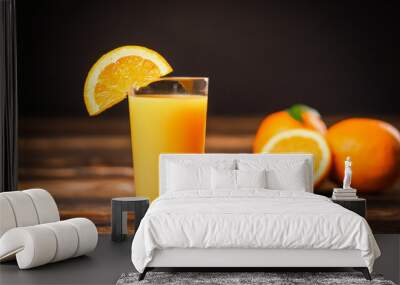 Fresh orange juice in the glass cup with oranges on old wooden table. Wall mural