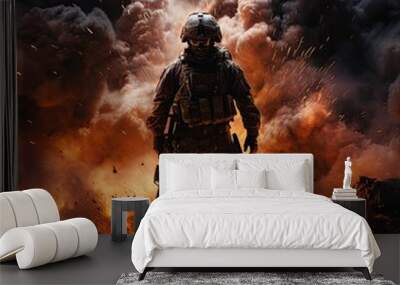 a military man in camouflage uniform with a weapon in fire and smoke. lone armed soldier in a fire.  Wall mural