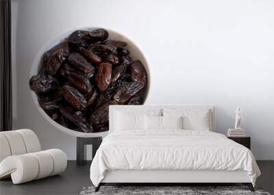 Dates inside a white bowl on a white background Wall mural