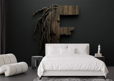 Rustic wooden letter F with dreadlocks design on dark background Wall mural