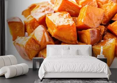 A pile of orange potato cubes. The cubes are cut into small pieces and lying on a white background. Wall mural