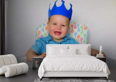 Little boy, Prince, baby king smiling sitting in a high chair. Funny knight Kid 1 year. Wall mural