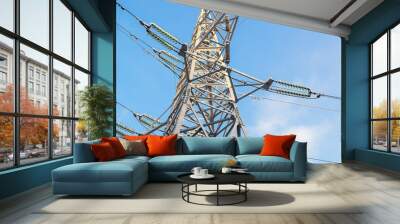 Metal support illuminated by bright sun. Power transmission tower against the sky. Electric power for transfer power by electrical grids. High voltage electric. Wall mural