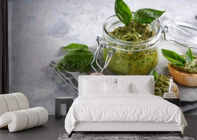 Toasts with traditional Italian basil pesto sauce and glass jar with pesto Copyspace Wall mural