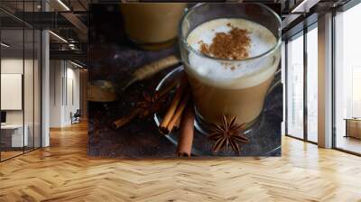 two hot cappuccino coffee with foam ,cinnamon , sugar and anise on a brown background Wall mural