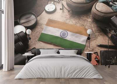 India Flag Between Traveler's Accessories on Old Vintage Map. Tourist Destination Concept. Wall mural