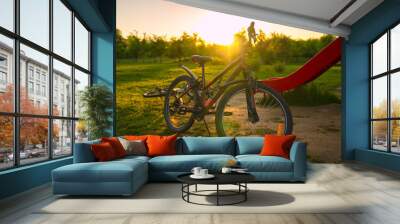 Bike at the summer sunset in the park. Cycle closeup wheel on bl Wall mural