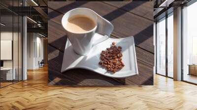 white mug of coffee with grains on a wooden background Wall mural