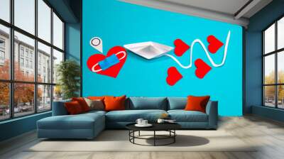 A paper boat sails through love during a pandemic. Interpersonal relations in the time of COVID 19. Wall mural