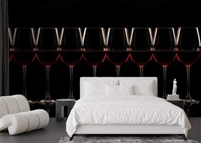 Row of eight red wine glasses, perfectly aligned against a black background, highlighting the elegance and richness of the wine Wall mural