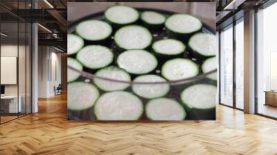 green raw zucchini sliced in a steamer with transparent walls and a black bottom is ready to cook . gluten-free vegan food Wall mural