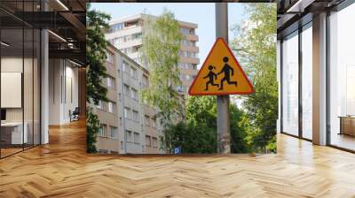 road sign made of metal triangular shape in orange color with the image of children on the street in Europe. careful children Wall mural