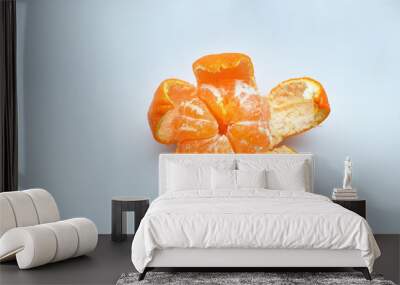 peeled tangerine on a white background.Orange fruits and peeled segment Isolated. Pile of orange segments Wall mural