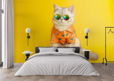 White british cat are wear sunglass and shirt in concept summer on the yellow background. Wall mural