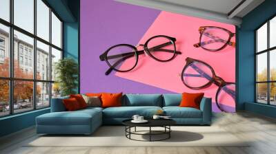 different eyeglasses on pink and purple geometric background, trendy eyeglass frames copy space Wall mural