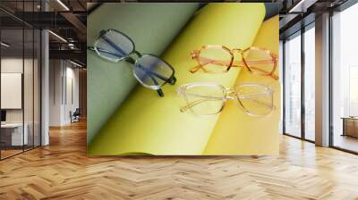 glasses on rolled paper, geometric background, green colors Wall mural