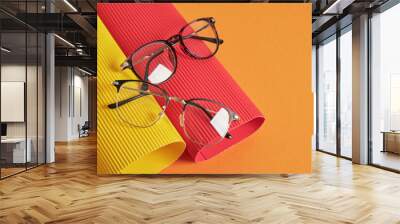 rolls of corrugated cardboard and several pairs of stylish glasses, eyeglass frames in the fashion trend Wall mural