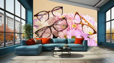 several trendy modern eye glasses on flowers. trendy eyeglasses Wall mural