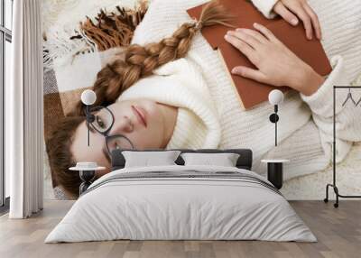 Soft portrait of teenage girl reading book at home Wall mural