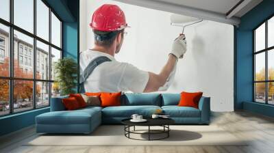 The building contractor paints the walls white with a roller Wall mural