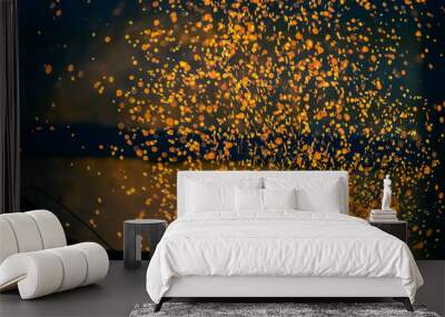 Flame and fire spark with bokeh  from burning charcoal on dark abstract background Wall mural