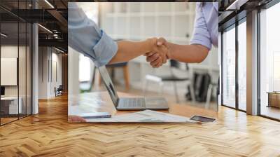 Asian businesswoman shakes hands with a successful woman entrepreneur in the business meeting. woman boss shakes hands and welcomes the new female employee Wall mural