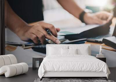 Close up accountant working on desk using calculator for calculate finance report at home office Wall mural