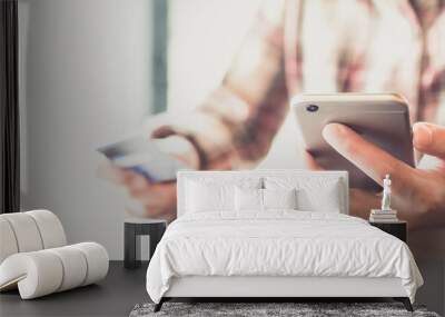 Close up hand of woman using smart phone for online shopping at home. Online shopping concept Wall mural