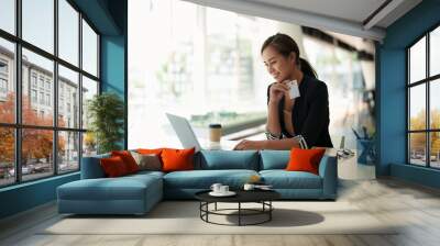 Close up of black girl hold bank credit card and type on laptop, shopping online using computer, buying goods or ordering online, entering bank accounts and details in online banking offer Wall mural