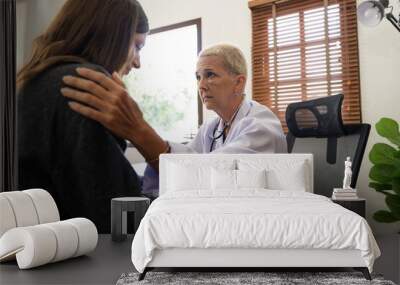 Female doctor giving hope and encouragement to stress woman patient at hospital. Doctor woman touching on patient shoulder to support take care and help. Support and encouraged Wall mural