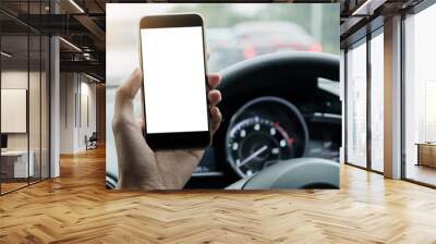 Man driver use his smart phone with blank screen  while driving Wall mural