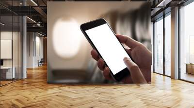 mockup image of a hand holding a smart phone with blank desktop screen on airplane window, blank scr Wall mural