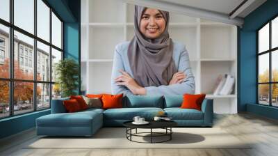 Portrait of confident muslim businesswoman in hijab standing workplace in office Wall mural