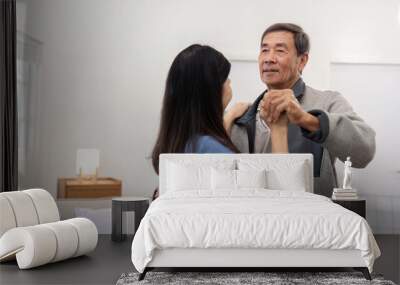 Senior couple sharing a dance in their cozy living room Wall mural