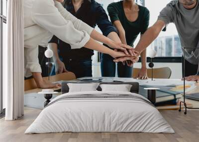 Teamwork business concept. Close up view of group of three coworkers join hand together during their meeting. Wall mural