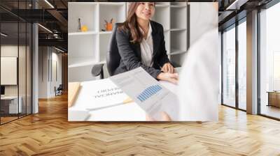 Teamwork of business two colleague analysis with financial data and marketing report graph, Young business woman two co worker discuss for calculating financial document Wall mural