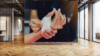 Therapist making asissistive device for immobilize patient hand. Splint service for hand injury rehabilitation of occupational therapy clinic. Wall mural