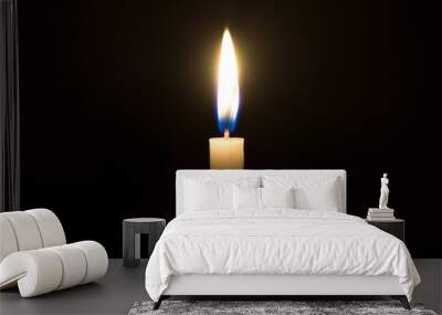 A single candle light glowing on a white candle in the middle part of frame on black background Wall mural