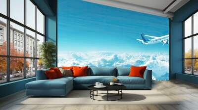 A white airplane is flying through a blue sky with clouds Wall mural