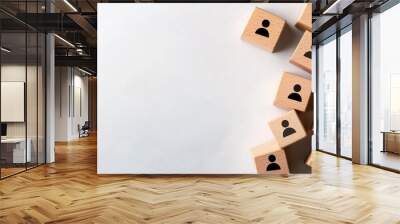 Wooden blocks with person icons arranged in a spiral on a smooth, light background, symbolizing growth, connection, and the evolving nature of human resources and social interactio Wall mural