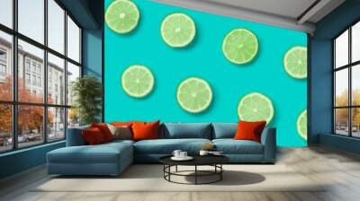 Fruit pattern of lime slices on blue background. Flat lay, top view. Wall mural