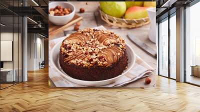 Chocolate sponge cake with pears and hazelnuts. Delicious autumn homemade sweet pie with seasonal fruits.  Wall mural