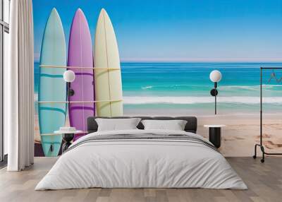 Vibrant surfboards lined up on a sandy beach with clear blue ocean and sky in the background, perfect summer scene.. Wall mural